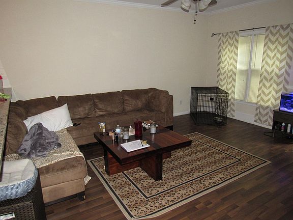 Large living room with vinyl flooring and walk-out to back p