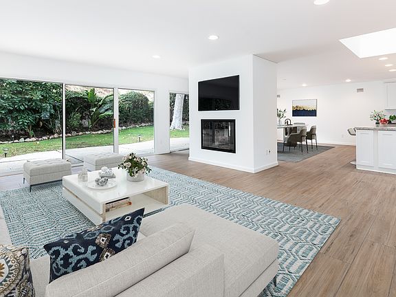 View of open concept, living room, dinning room in the back and kitchen