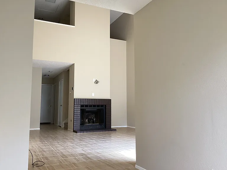 Living room featuring vaulted ceilings and fireplace
