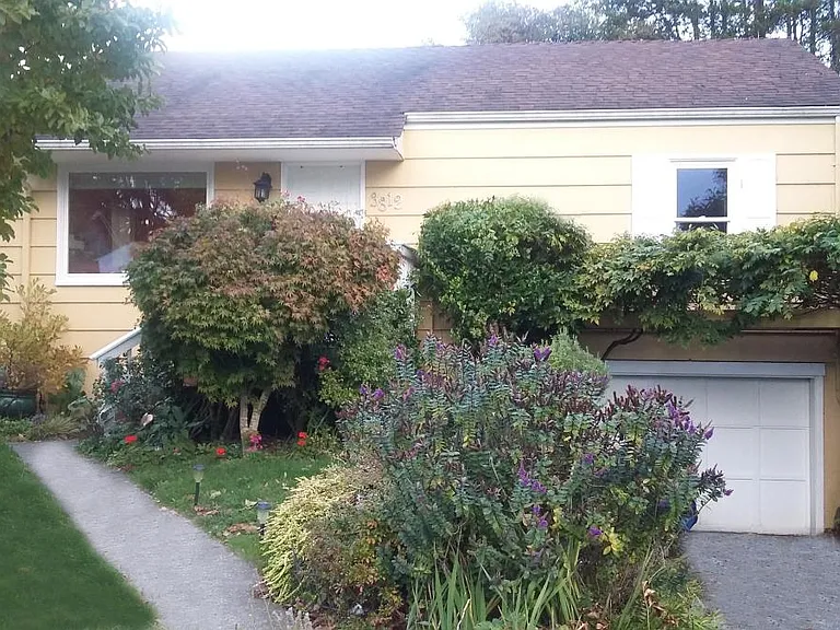 Front of house with attached garage.
