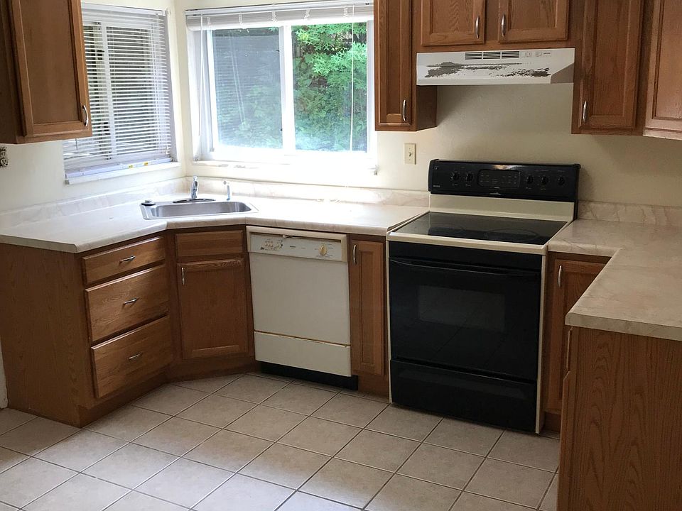Eat in kitchen with stove, dishwasher and refrigerator. 