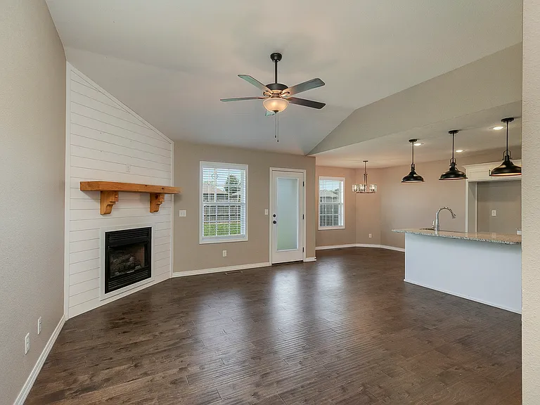 fireplace and ceiling fan in family room