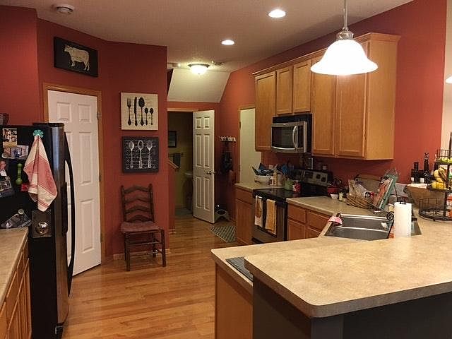 Open kitchen with stainless steel appliances, maple cabinets