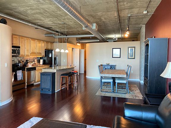 Kitchen and dining room view looking towards the front entrance hall and media room/den.