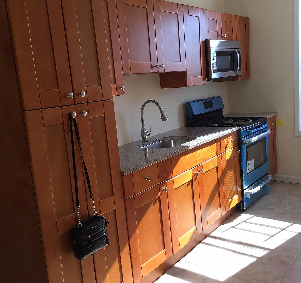 Custom cabinetry ,granite counter top, stainless steel appliances,ceramic tile floor, window, 11 foot ceiling