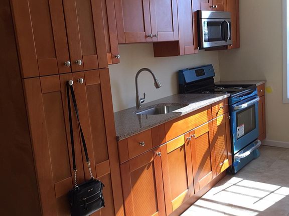 Custom cabinetry ,granite counter top, stainless steel appliances,ceramic tile floor, window, 11 foot ceiling