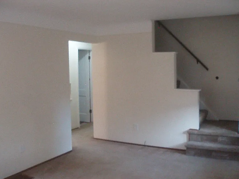 living room looking towards stairs to 2nd floor