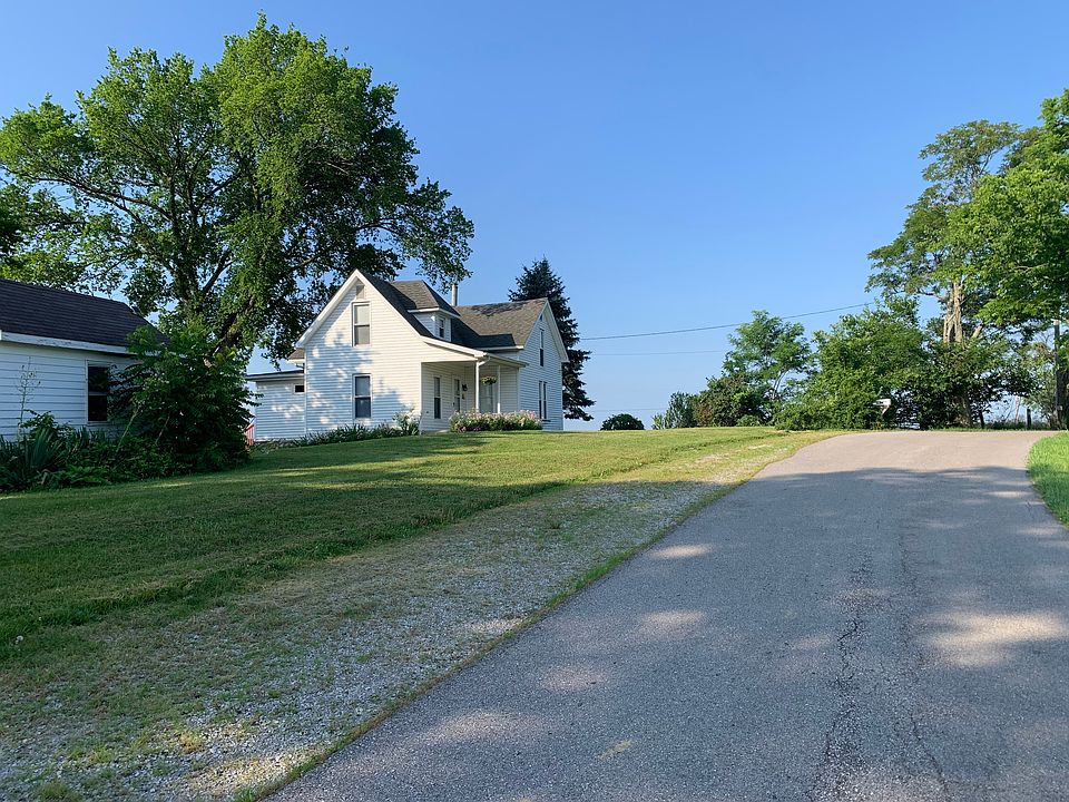 Front porch and storage building on country road.