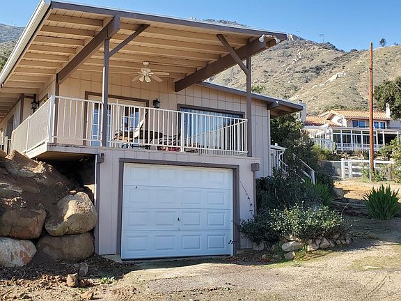 Garage is for storage only. Not large enough for autos. Carport being installed where truck is parked.