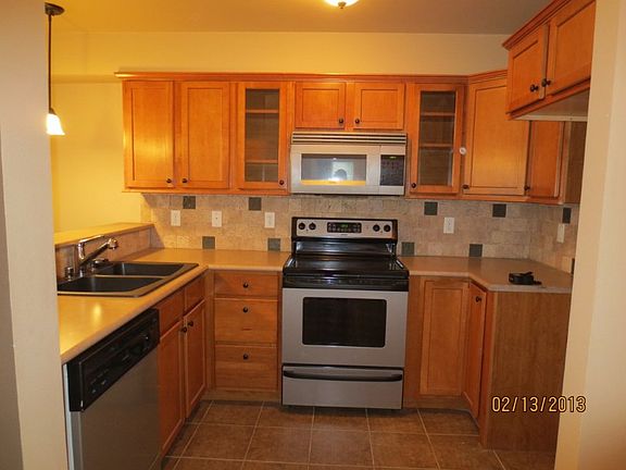 Kitchen with updated appliances just to the right after entry into condo. Buyer to purchase a refrigerator.