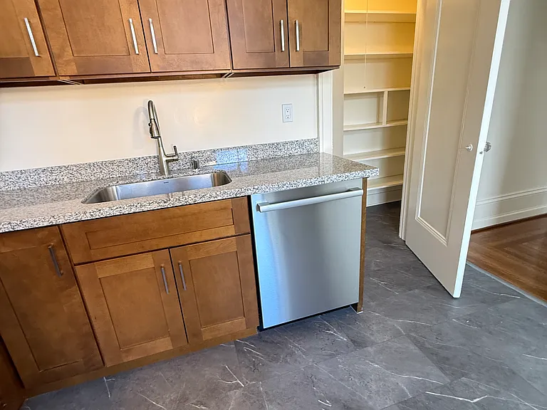Dishwasher and sink. Walk in storage pantry is to the right
