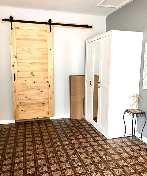 Third bedroom and doorway to laundry room.