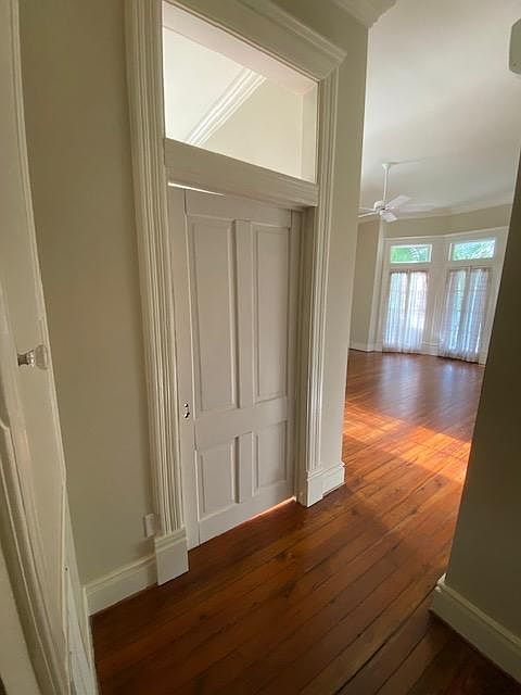View from hallway inti livingroom. French door going out to front covered porch. Original heart pine floors.