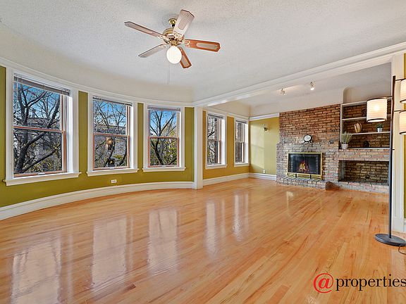 Living & Dining Room w/ Fireplace & Exposed Brick