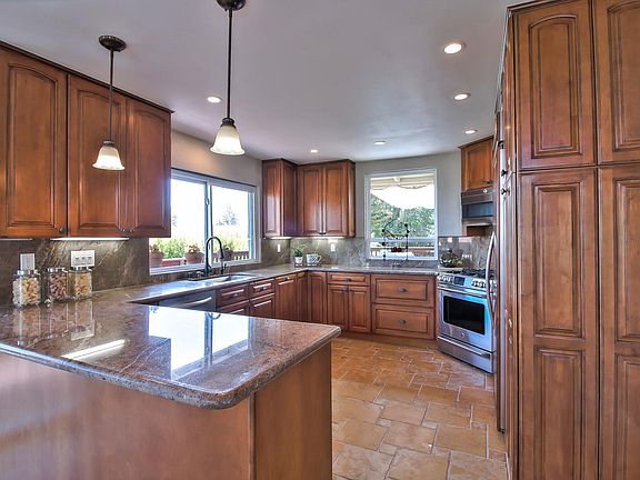 Deep wood/dark brown and rust granite counter tops. All new stainless-steel GE Profile appliances with double-wide Kitchen Aid refrigerator. Microwave oven and dishwasher are new installed in 2018. The wine-chiller is also new, 2017. Recessed lighting