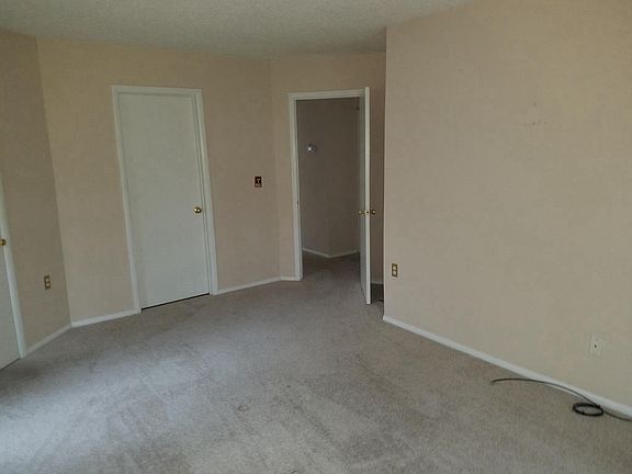 Large Master Bedroom with sliding glass door to rear and wal