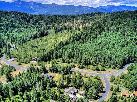 This home is nestled in trees on a south facing .74 acre level site on a quiet cul-de-sac.  A 50' easement behind the home provides additional privacy. Two dry river beds wind through the fir trees on the sides of the driveway.