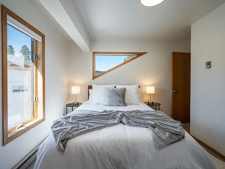 Room with a queen bed and closet and southern view.