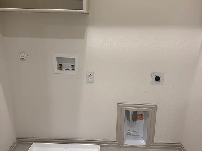 Washer dryer room with storage cabinet