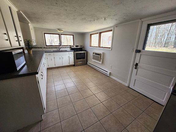 Kitchen view from the hallway to the bedrooms. Kitchen has exterior door to the deck and back yard.