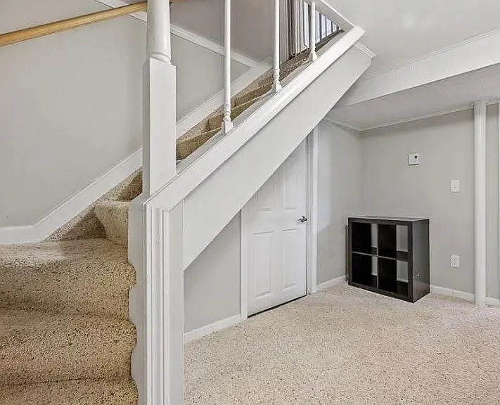 Basement stairs to storage and laundry room.