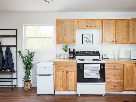 Fully stocked kitchen with dishwasher, microwave, stove, coffee maker & mini fridge/freezer. Pots/pans, cookware, utensils, plates, etc. included