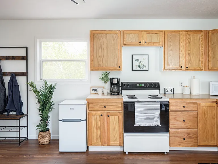 Fully stocked kitchen with dishwasher, microwave, stove, coffee maker & mini fridge/freezer. Pots/pans, cookware, utensils, plates, etc. included