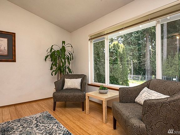 Quite a lovely view from the front of this home.  The community water tank is across the street beautifully hidden amongst firs & cedars.  This is an added level of privacy with this sweet home. 