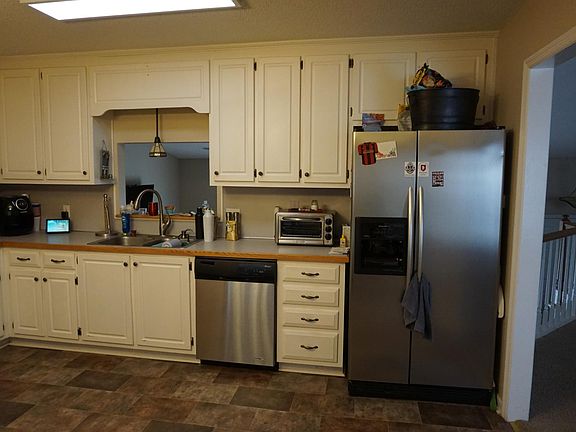 Kitchen view with a speakeasy window to Den