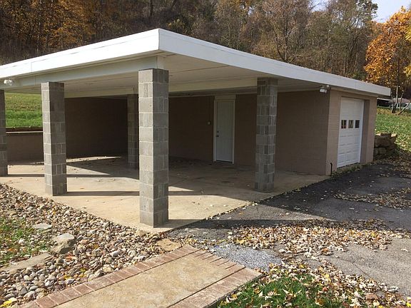 Detached one-car garage with additional covered area.