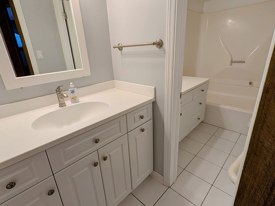 Main bath features two vanity sinks and tall medicine cabinet storage