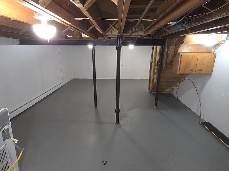 Clean lower level with open floor area, laundry space, and additional storage possibilities.