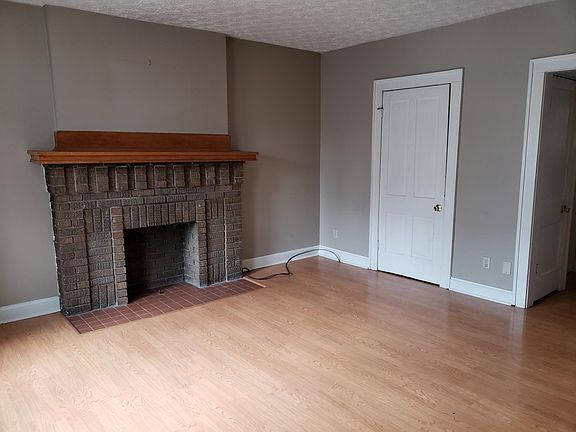 Living rom with mantle and closet