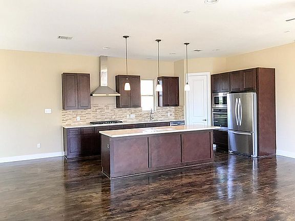 Beautiful Kitchen with natural stone back splash, granite counter tops, espresso cabinets, molding,  Oak hardwood floors.