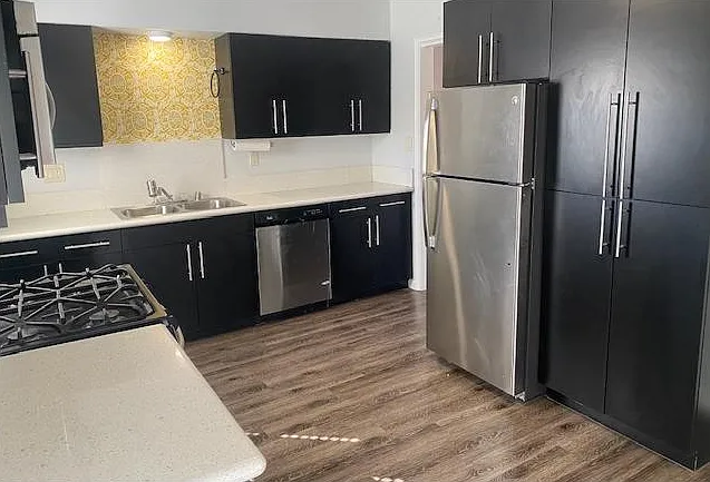 Kitchen with microwave, fridge, range and dishwasher. Plenty of storage.