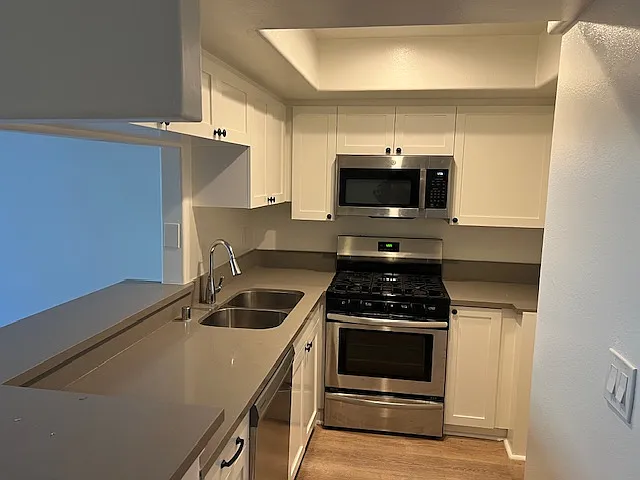 Renovated kitchen open to living room and dining area