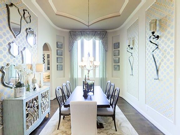 The formal dining room enjoys an elegant design with increased privacy for celebrations or gathering