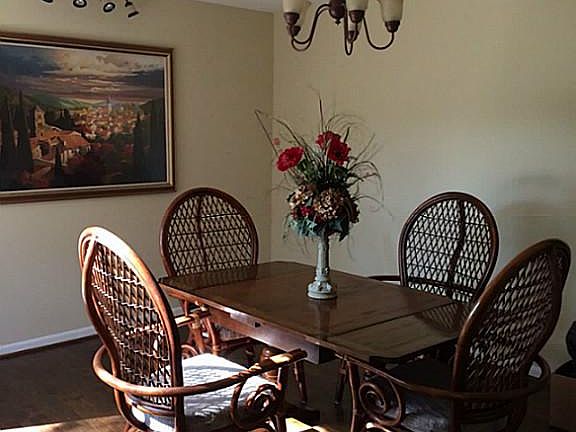 THE LARGE DINING ROOM OVERLOOKS THE PARKLIKE BACK YARD