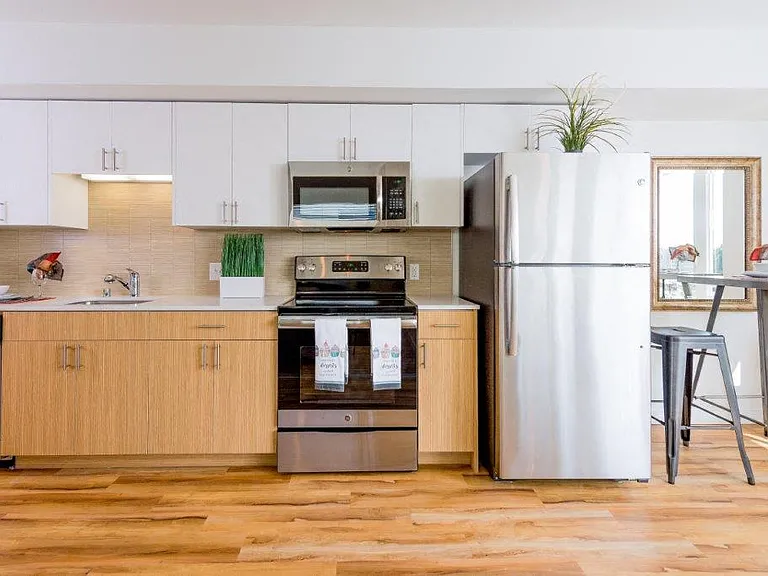 A modern kitchen in Lillehammer Apartments equipped with stainless steel appliances.