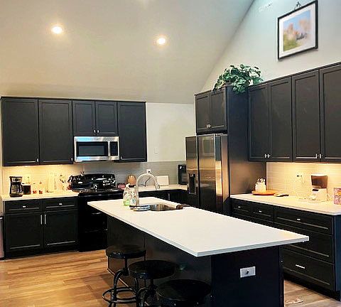 Fully stocked kitchen will all new appliances, including stove, microwave, dishwasher, and full size refrigerator