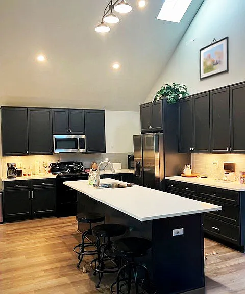 Fully stocked kitchen will all new appliances, including stove, microwave, dishwasher, and full size refrigerator