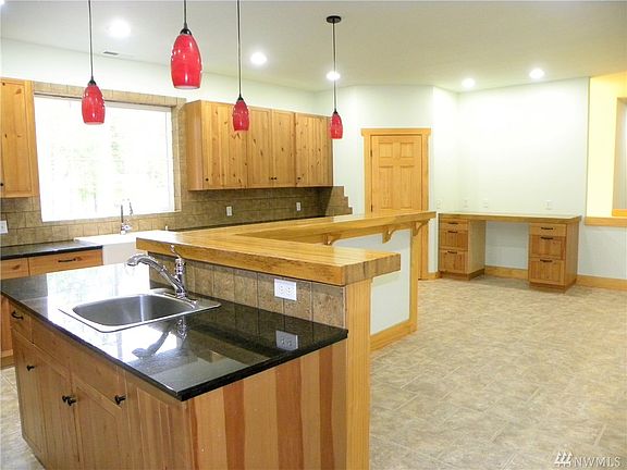 Another view of the large kitchen showing the veggie, large breakfast bar, desk area and walk-in pantry. 