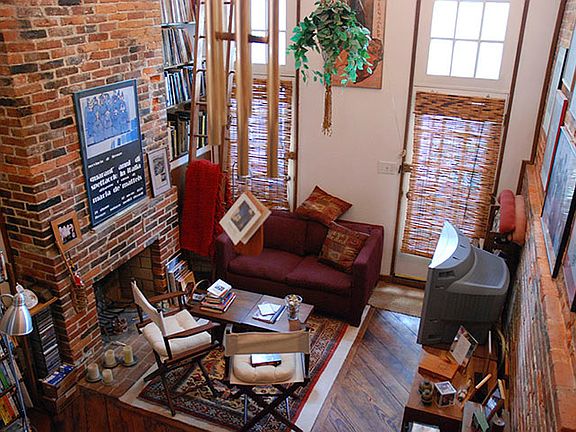 Open apace living area with fireplace. Doors leads to fenced courtyard.