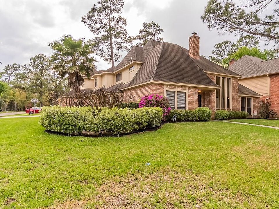 This custom home sits on a large corner lot with pretty landscaping.