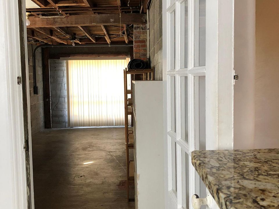 Kitchen opens to garage-sized storage and laundry.