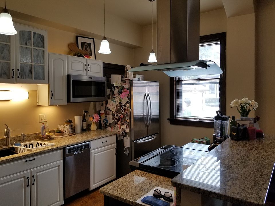 Nice view of architecturally interesting range hood over glass top stove