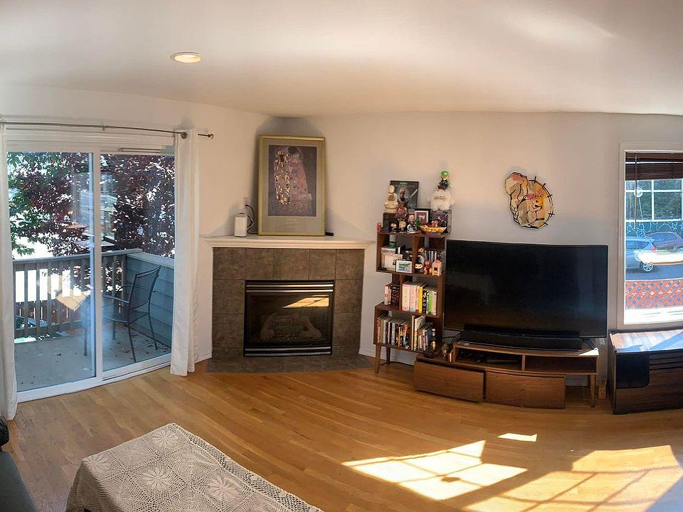 Living room, with outdoor balcony and fireplace. (Any furniture you see we can keep here, or take away.)
