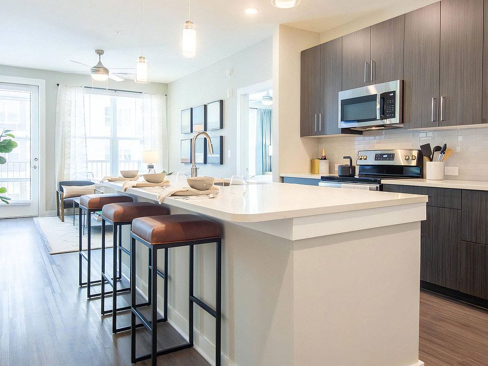 Open Kitchen Featuring Bar Seating and Adjacent Living Area