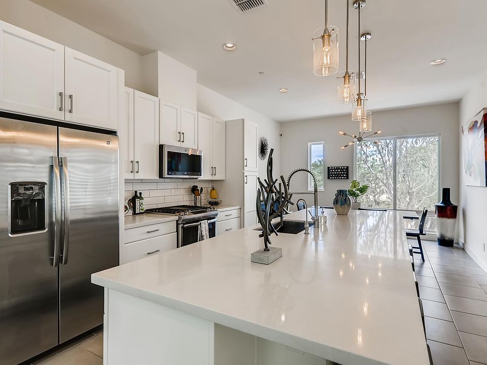 White shaker cabinets, stainless steel appliances and large 10' oversized quartz countertop
