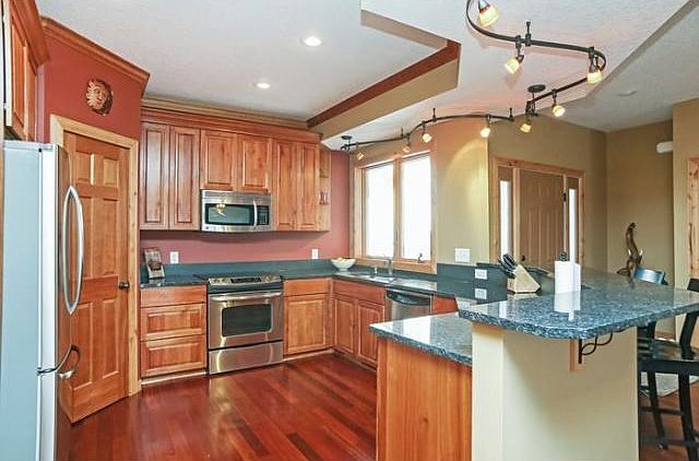 Huge kitchen w/ GE stainless steel appliances. Blue pearl granite w/ soap stone backsplash. Rustic cherry cabinets and Brazilian cherry hardwood floors.